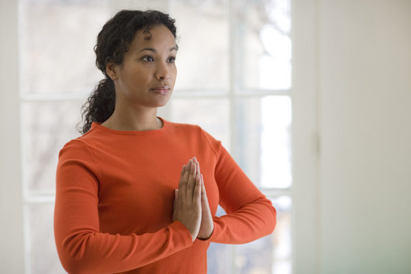 Pretty black woman practicing yoga