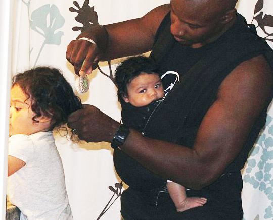 black man doing daughters hair
