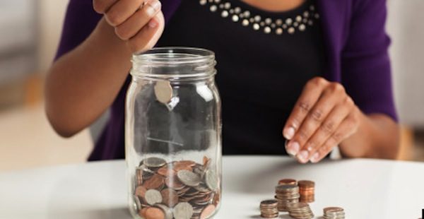 Attractive young African American woman working on finances at home wearing purple jacket sitting at dining table.; Shutterstock ID 111349808; PO: aol; Job: production; Client: drone