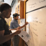 students at a whiteboard