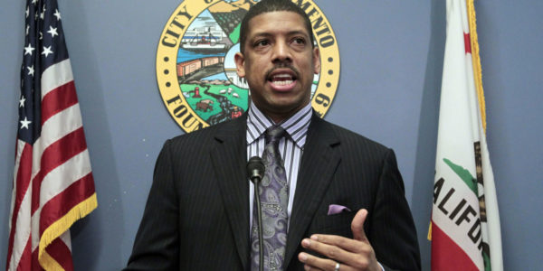 Kevin Johnson in front of a conference background